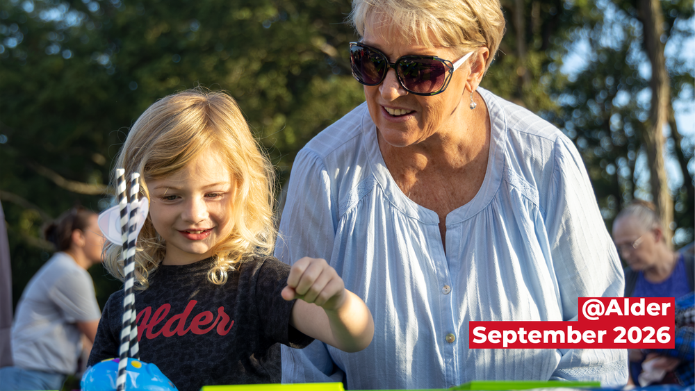student smiling with grandparent