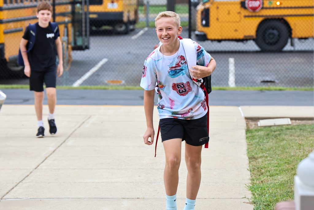 student smiling by bus