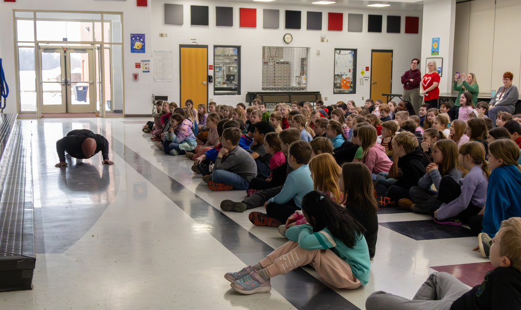Nickey doing pushups in front of students
