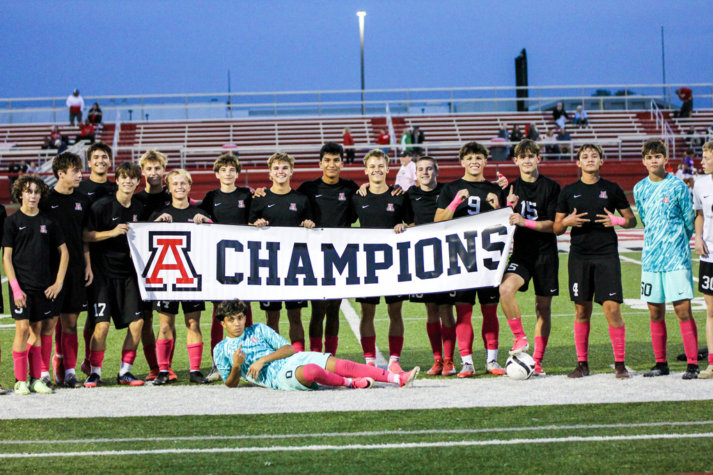 Boys soccer with champions banner