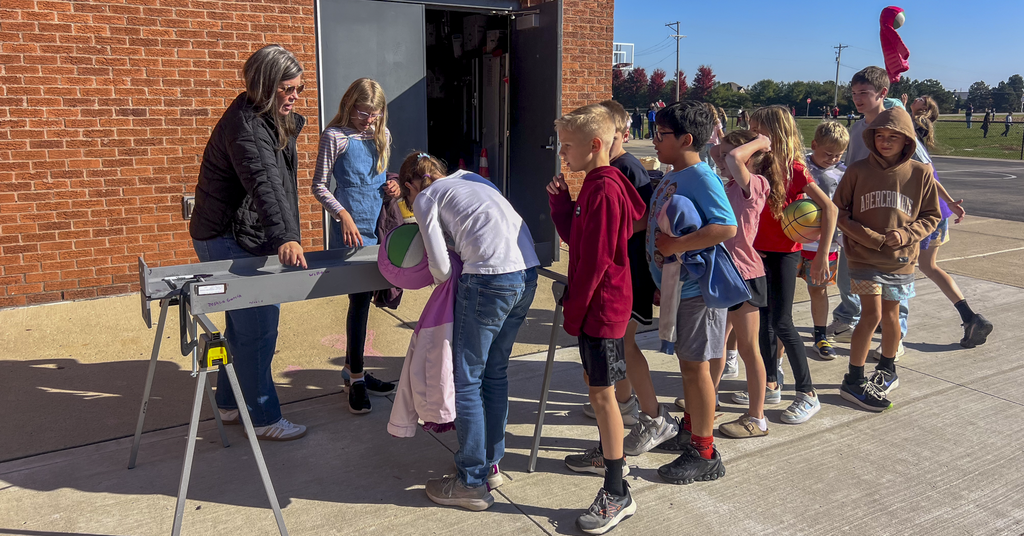 students at beam signing