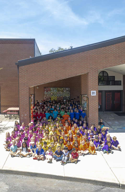 monroe students in front of building
