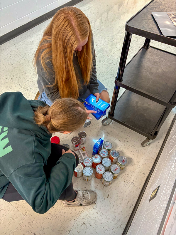 students separating canned good items