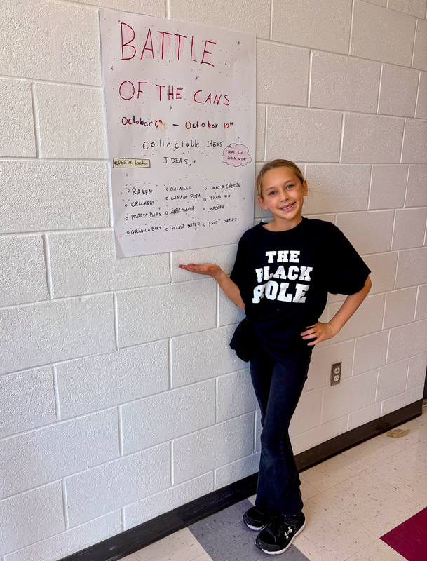 student posing with poster