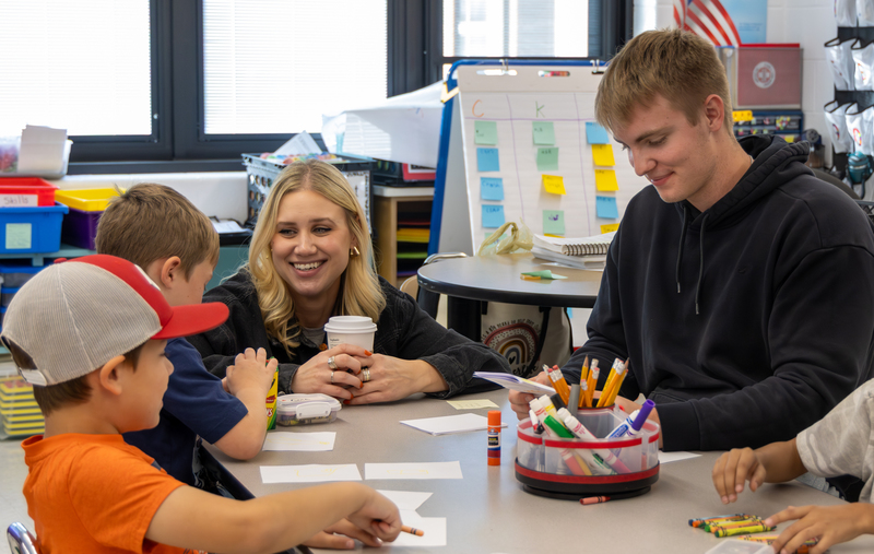 students and staff smiling