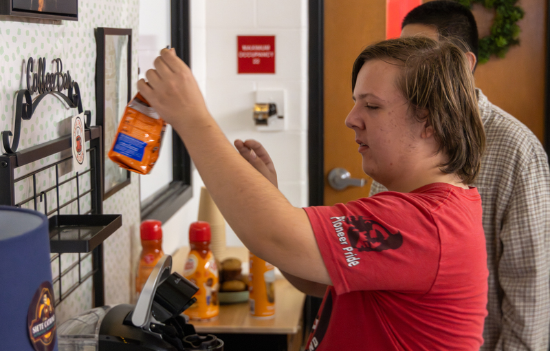 student working in classroom cafe