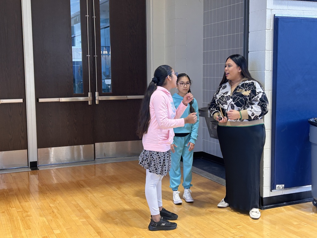 5th Grade Leader Students showing off their favorite parts of school to the NC TOY Ms. Candaso