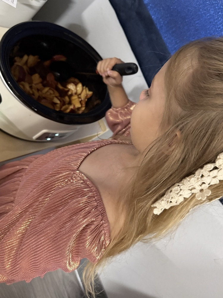 Helping stir the applesauce 