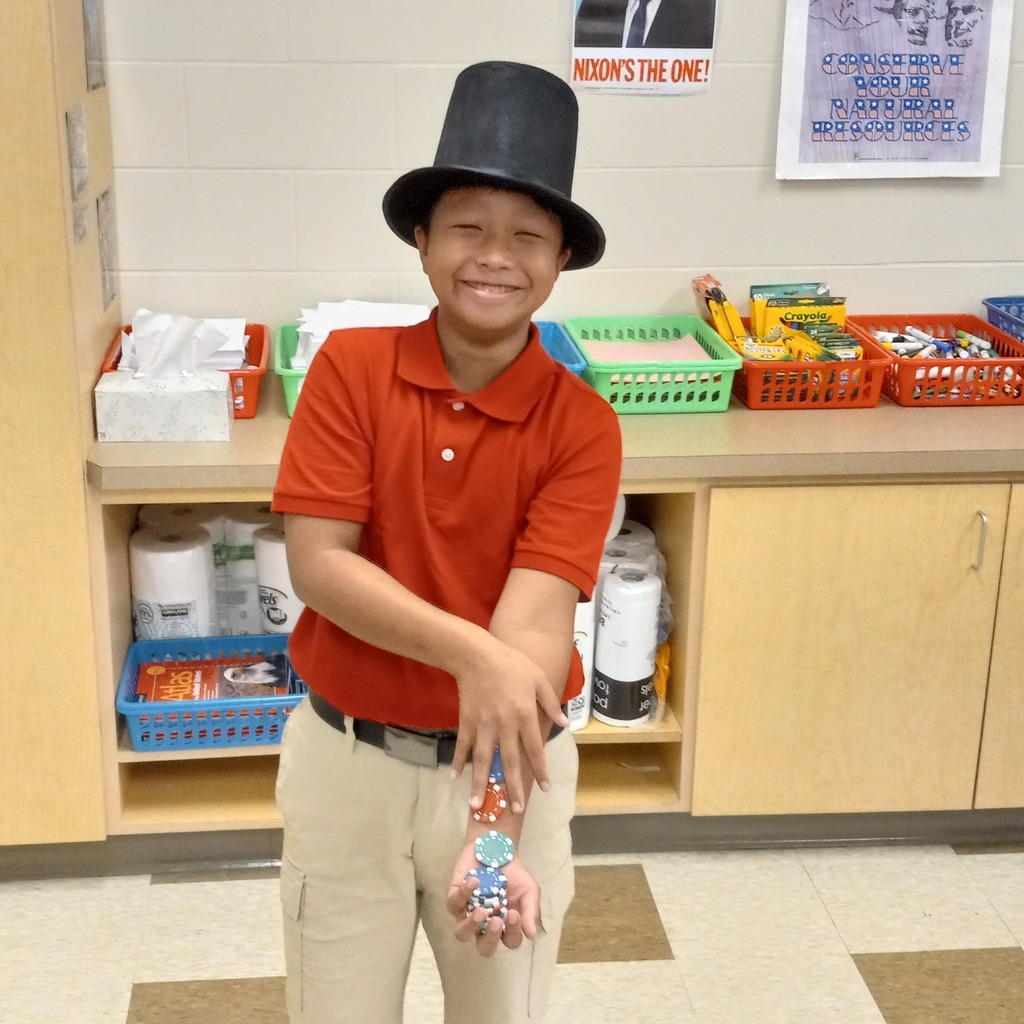 student wearing a top hat posing with poker chips