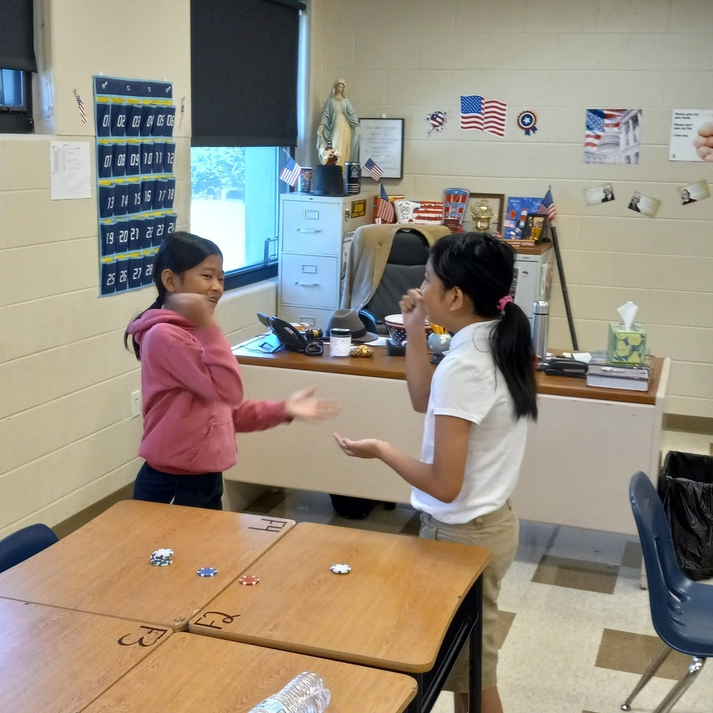 students playing paper rock scissors for poker chips