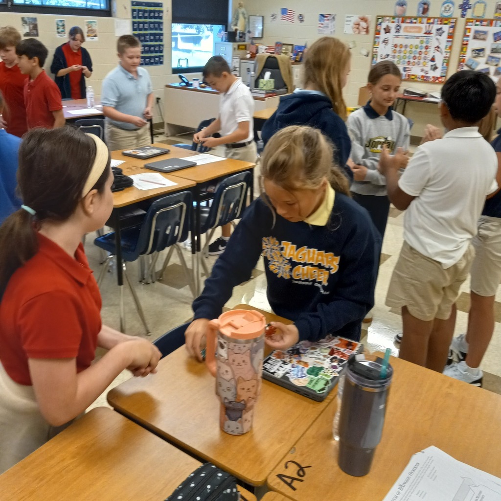 students standing working throughout a classroom