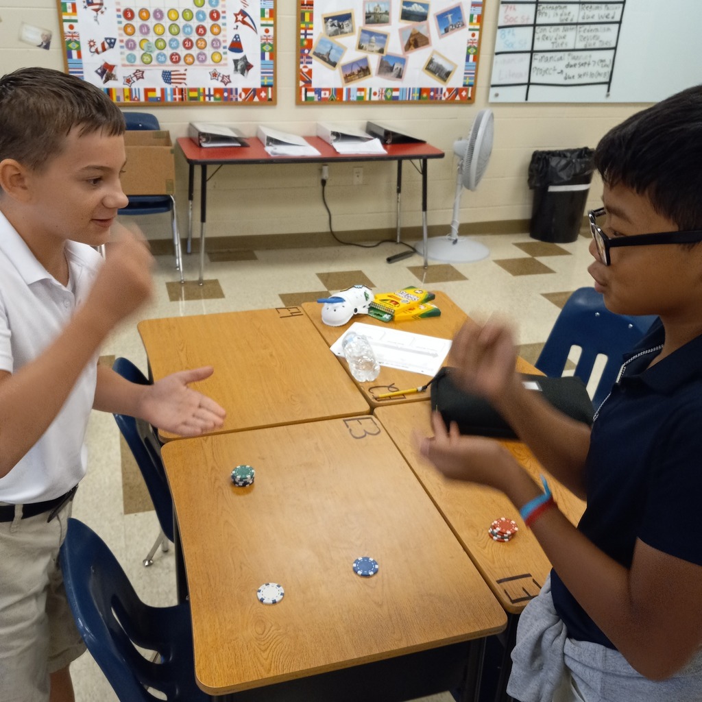 students playing paper rock scissors for poker chips