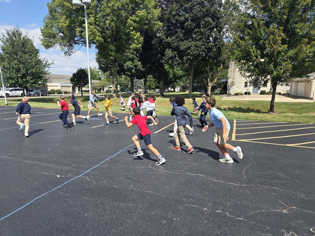 group of students running at recess on the blacktop