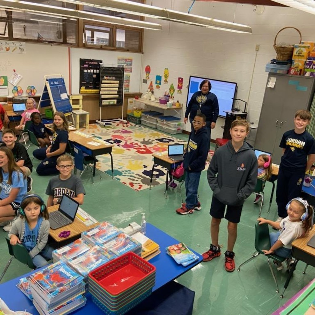 7th graders helping kindergartners take MAP tests on their Chromebooks