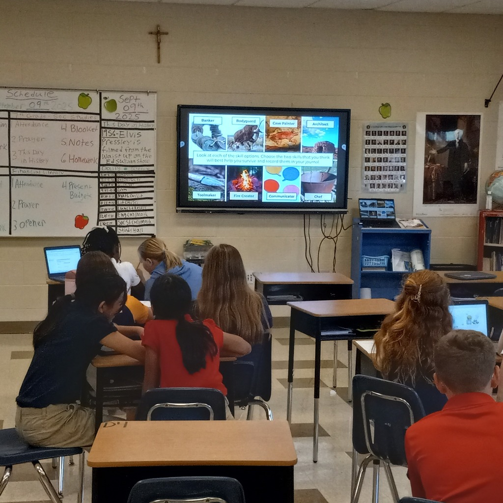students working together in groups to solve the clues that are displayed on the digital panel