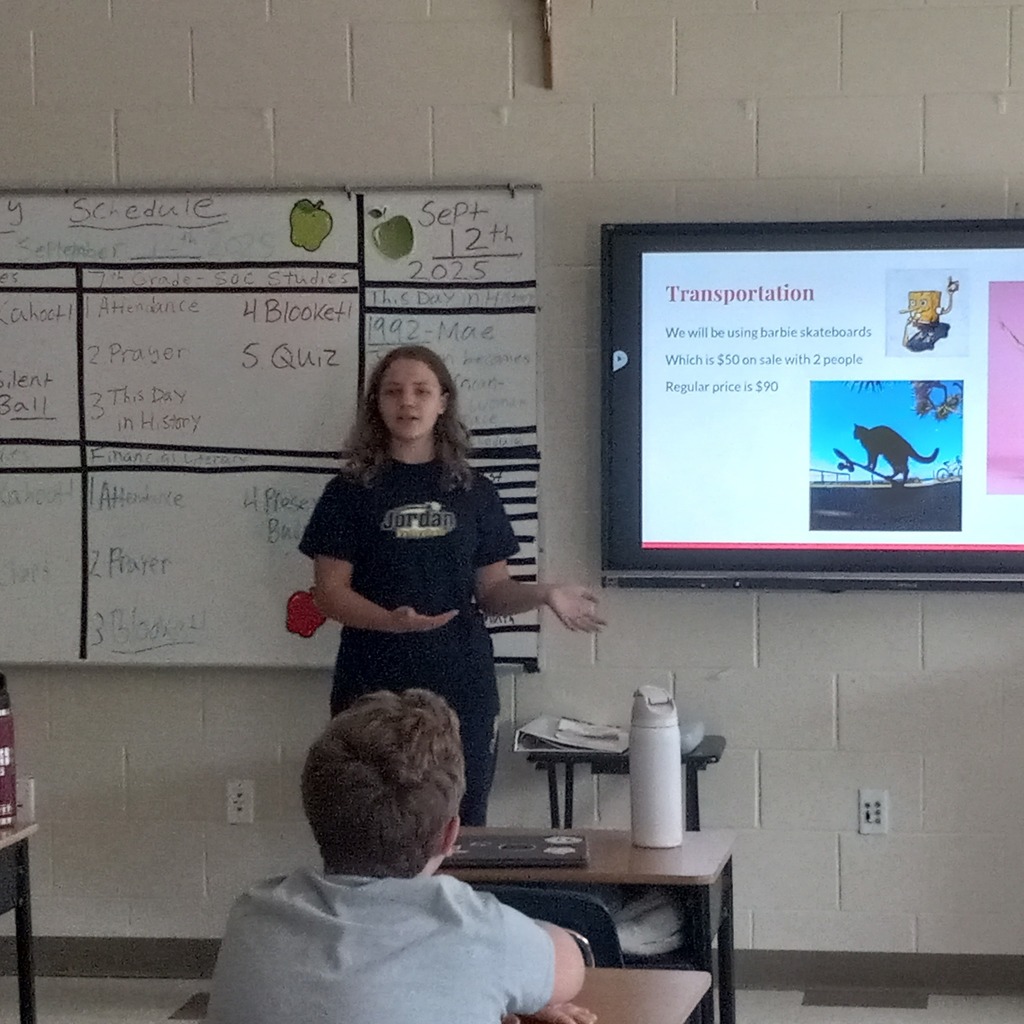 student presenting information on a digital board to the class