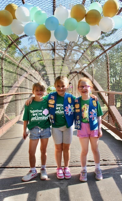 girl scouts bridging ceremony on a pedestrian walking bridge