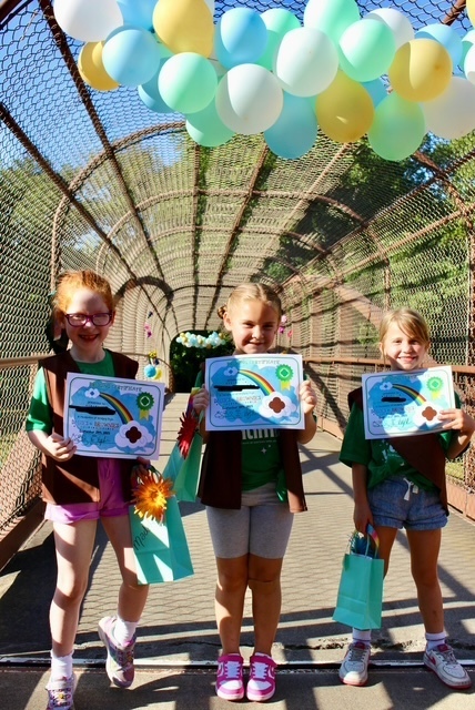 girl scouts bridging ceremony on a pedestrian walking bridge