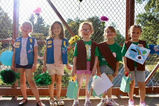 girl scouts bridging ceremony on a pedestrian walking bridge