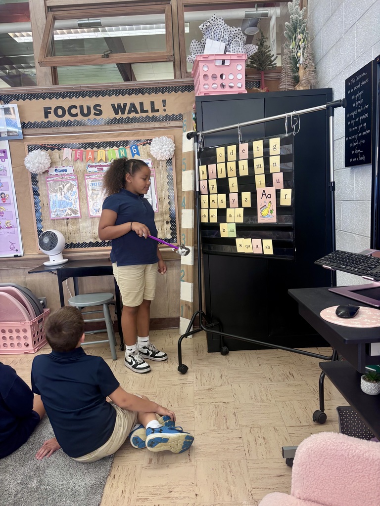 student pointing out letter sounds