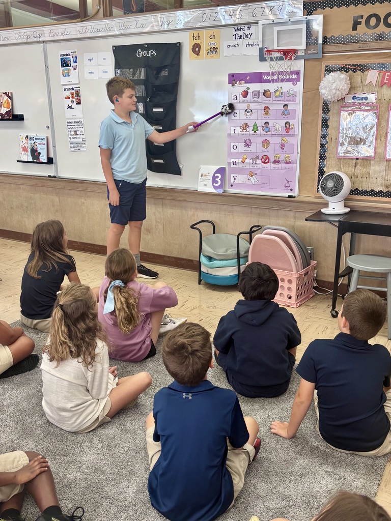 student pointing out vowel sounds