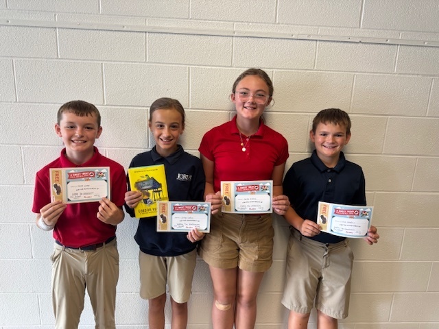 4 students posing with reading certificates
