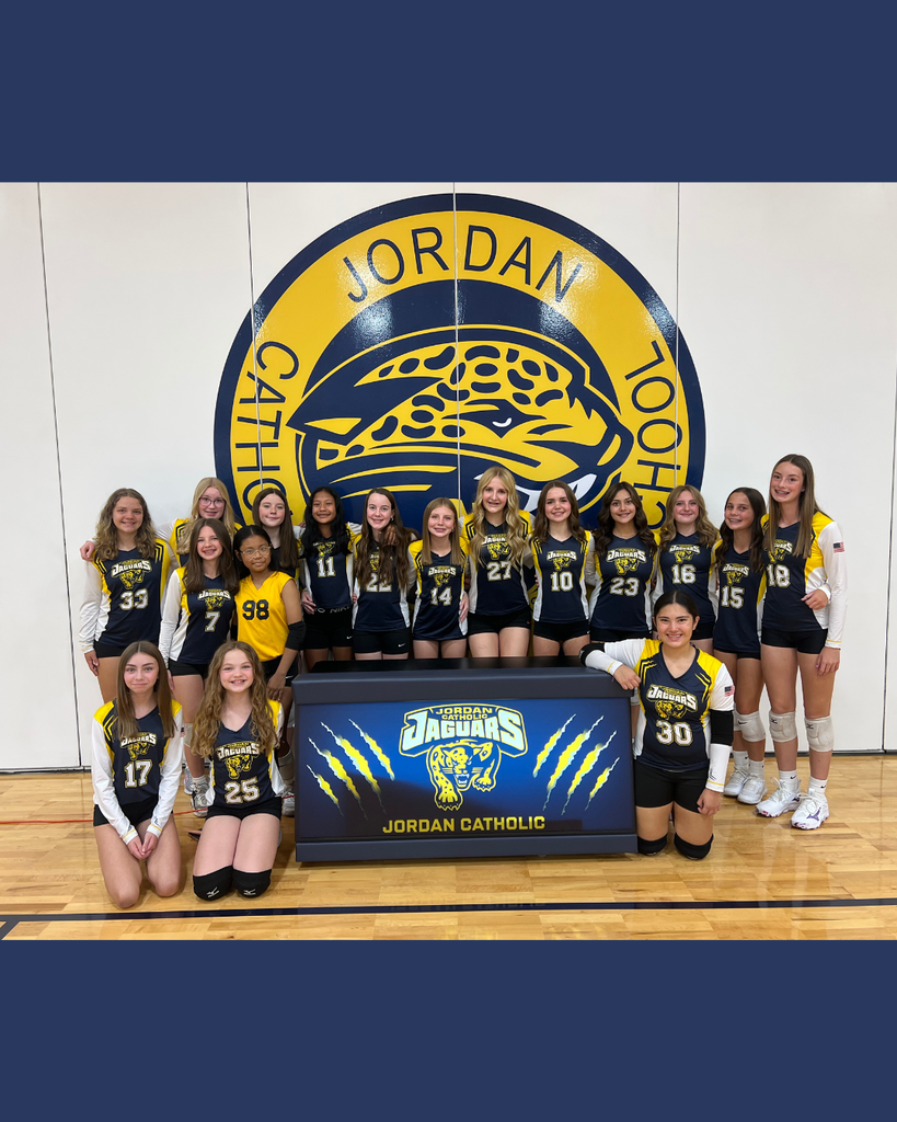team photo posing with new score table in school gym