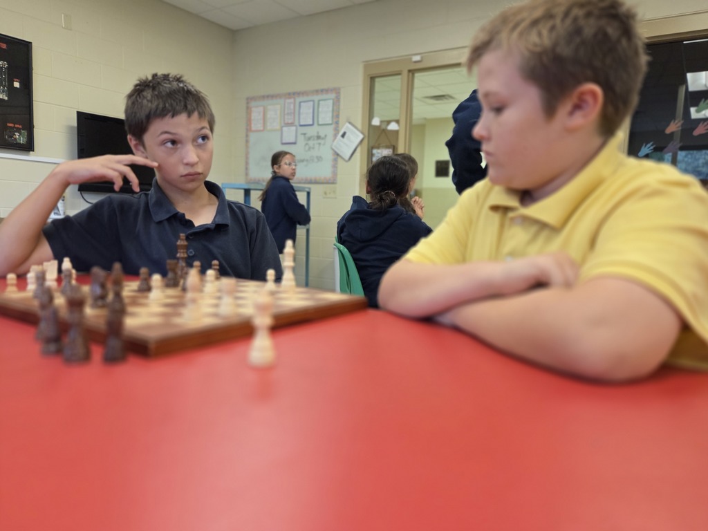 students playing chess in a classroom