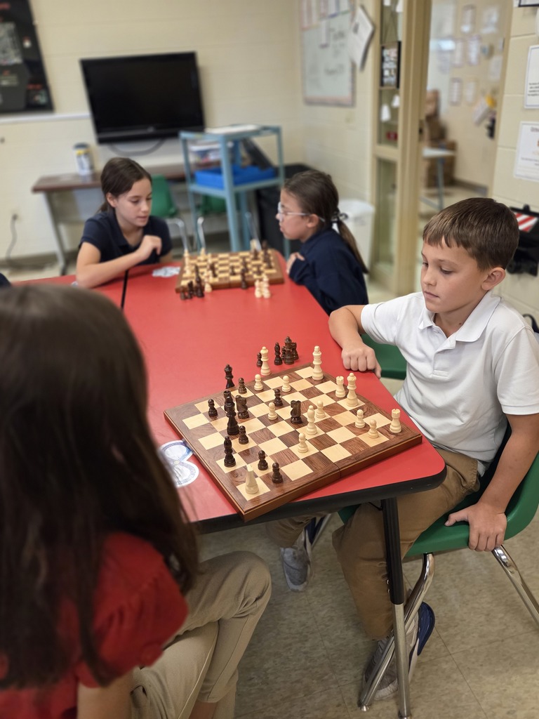 students playing chess in a classroom