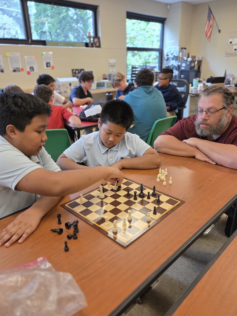 students playing chess in a classroom