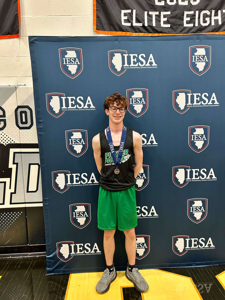 student athlete posing in front of IESA banner