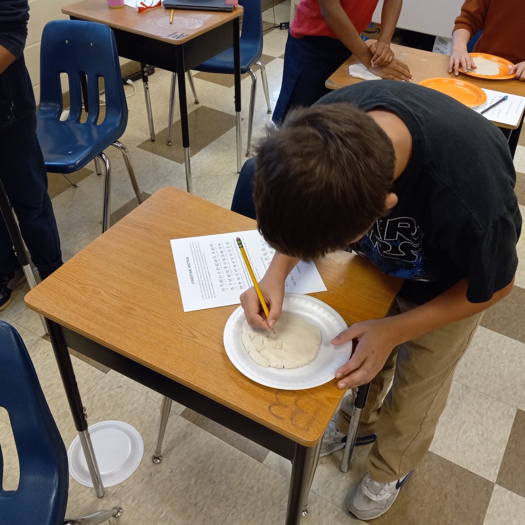 students writing cuneiform