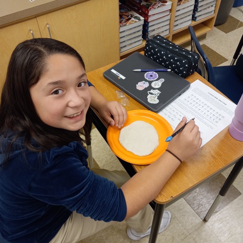 students writing cuneiform
