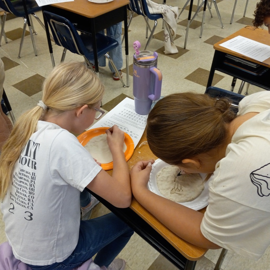students writing cuneiform