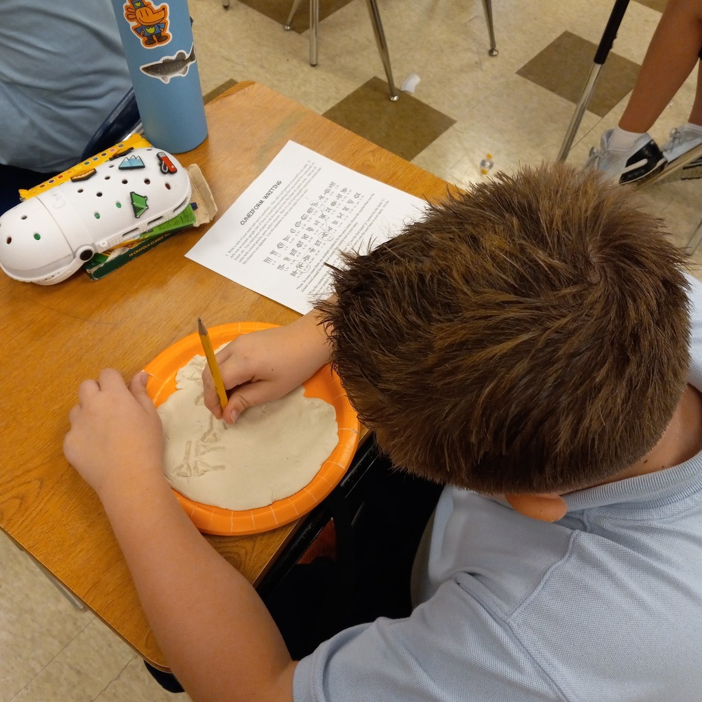 students writing cuneiform