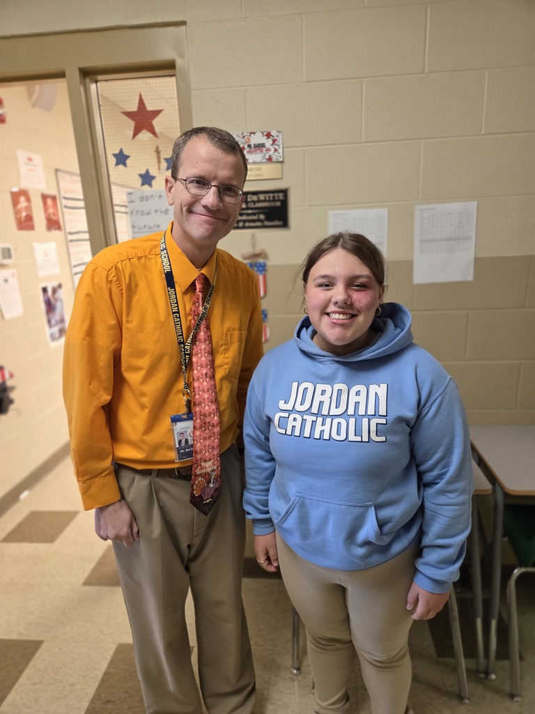 teacher and student posing in the hallway