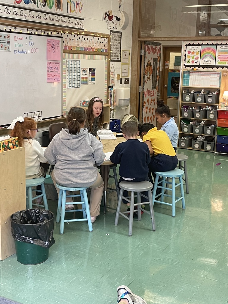 teacher working with students at small group table