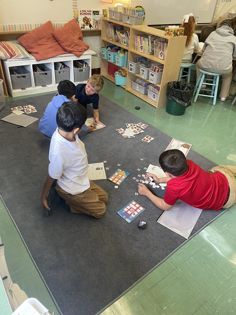 students working together on a classroom carpet
