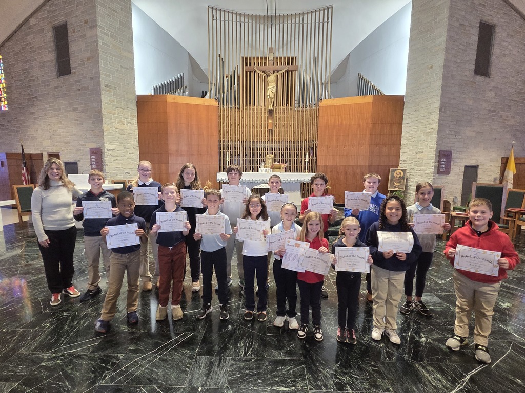 group photo of students holding certificates on a church altar