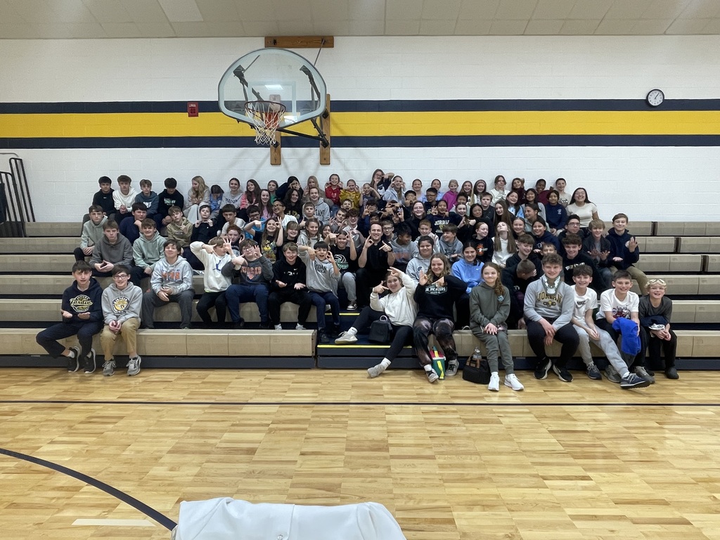 group photo of junior high students with a priest