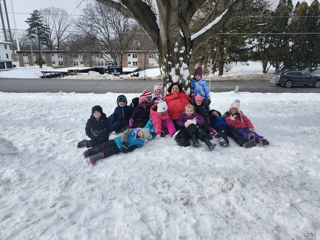 group photo of students with teacher in the snow