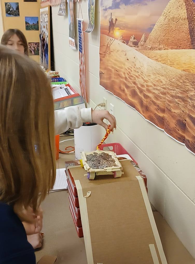 finished "car" made from cardboard, tape, and botte caps