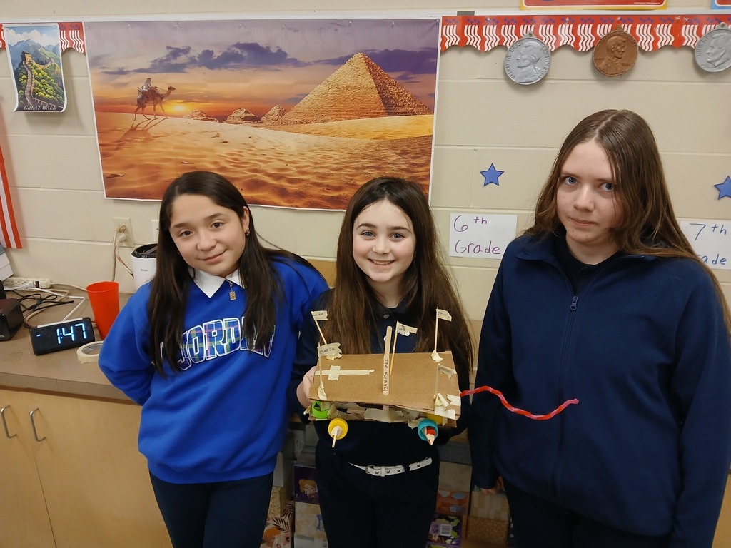 students using cardboard and tape to build a car