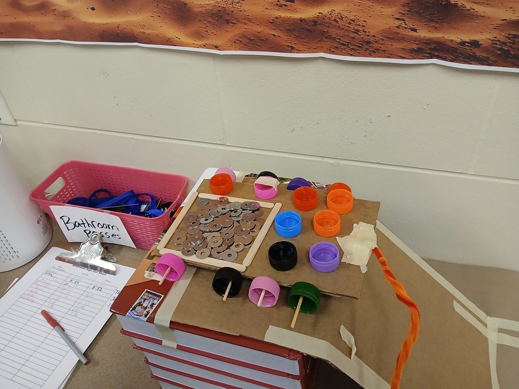 finished "car" made from cardboard, tape, and botte caps