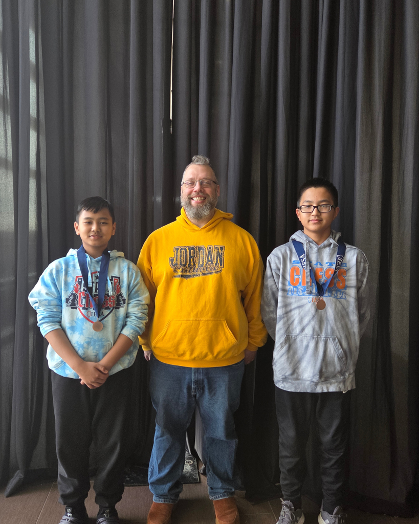 Chess coach posing with 2 teammates