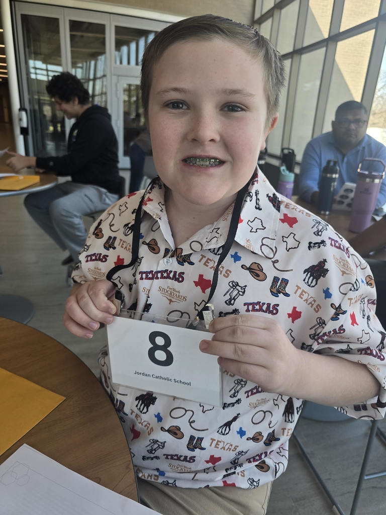 student showing off number placard