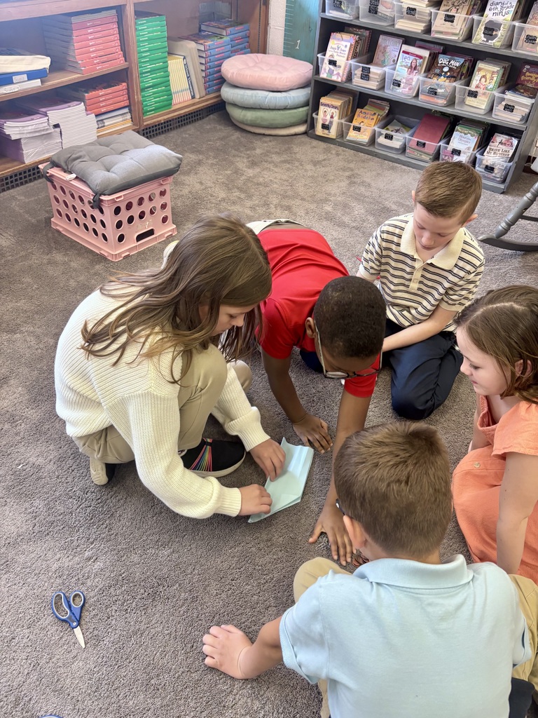 students making paper airplanes