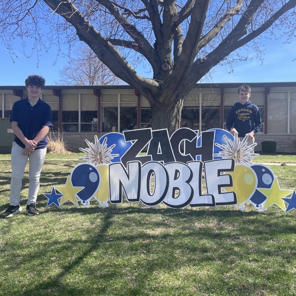 students posing with yard signs