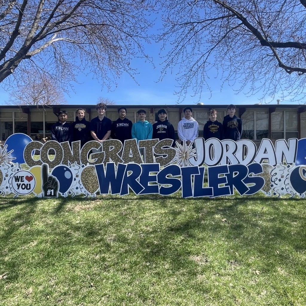 wrestlers posing with yard signs
