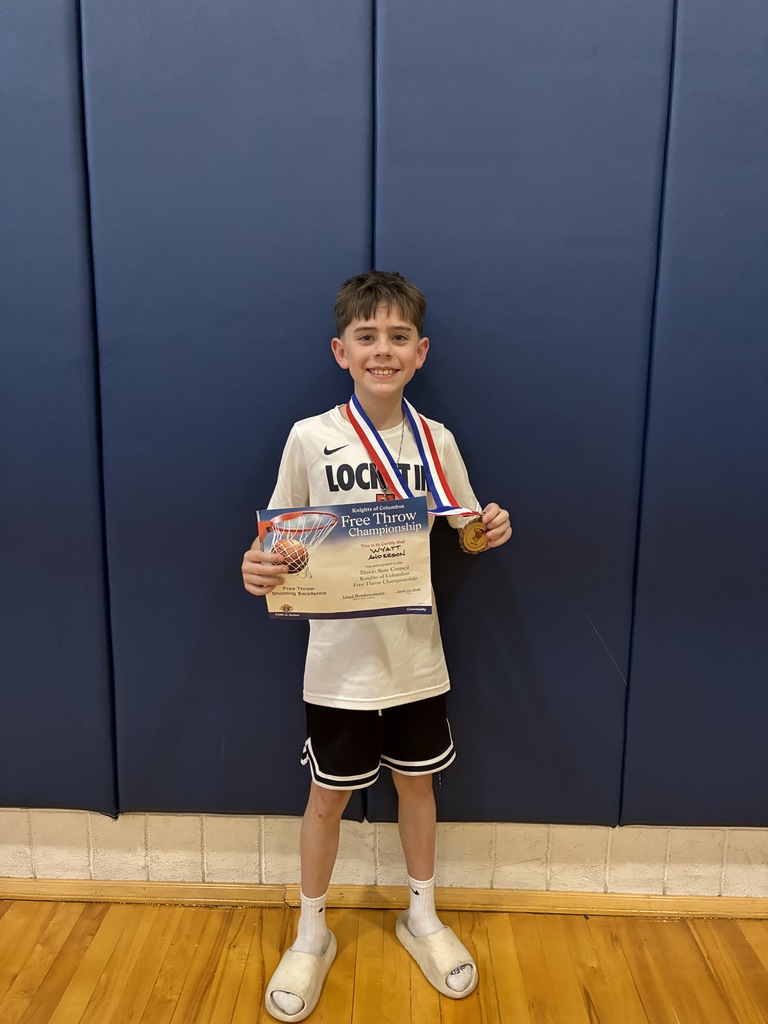 Young boy posing with certificate and medal